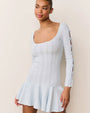 Light blue long-sleeve knit mini dress with a scoop neckline, fitted bodice, and flared hem. The sleeves feature open slits tied with small bows along the arm.