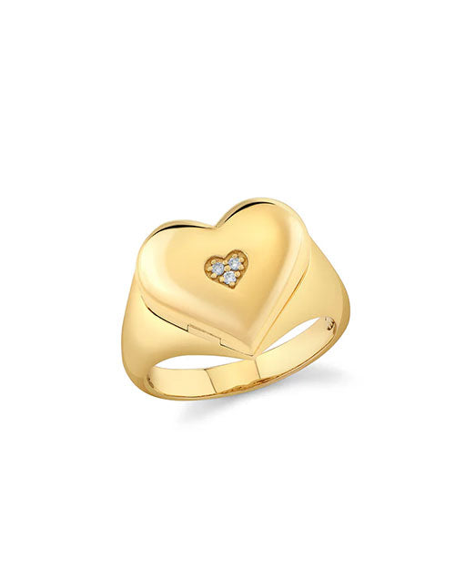 Gold ring with a heart-shaped design featuring small diamond-like stones arranged in a smaller heart pattern, polished for an elegant finish.