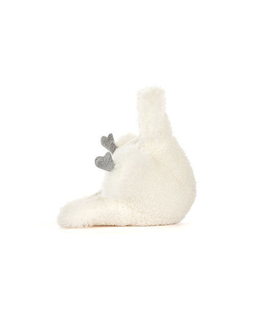 Plush toy resembling a white bird lying on its back with a fluffy, round body, one visible wing, and two small grey feet sticking up in the air.