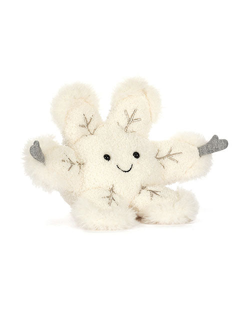 White plush toy shaped like a snowflake with six fluffy arms ending in gray tips, embroidered branch-like details, and a smiling face with black eyes and a curved mouth.
