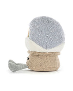 Plush toy with a textured light gray head and a beige burlap-like body, featuring small black eyes and a gray limb or accessory attached to the left side.