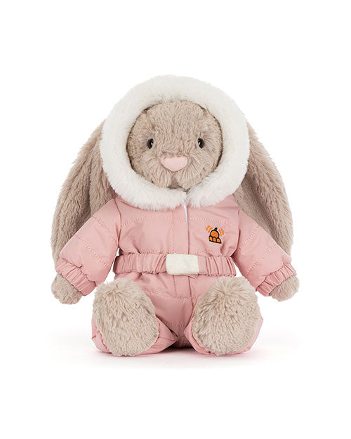 Plush rabbit toy with long floppy ears, dressed in a pink hooded winter outfit with white fur trim, an embroidered orange bell on the chest, matching pink pants, and a white belt.