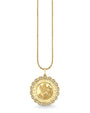 Gold necklace featuring a round Saint Christopher medallion pendant. The pendant has an engraved depiction of Saint Christopher carrying a child, surrounded by the words ‘SAINT CHRISTOPHER PROTECT US.’ The edge of the medallion is scalloped and adorned with small clear gemstones.