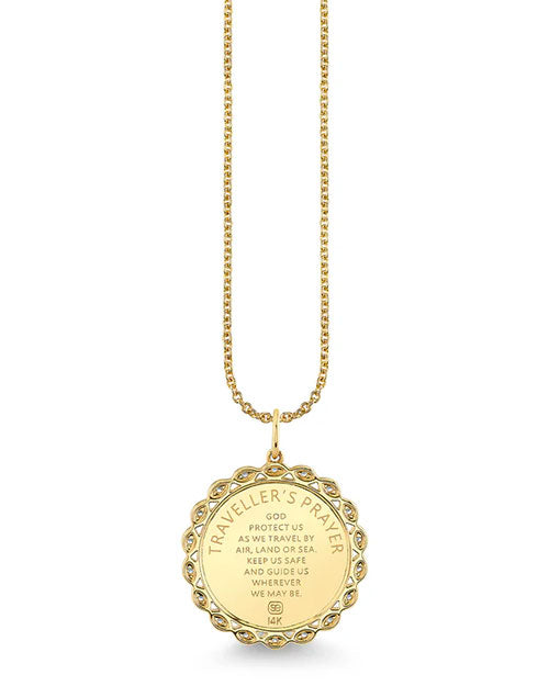 Gold necklace featuring a round pendant engraved with the Traveller’s Prayer. The text reads: ‘Traveller’s Prayer. God protect us as we travel by air, land or sea. Keep us safe and guide us wherever we may be.’ The pendant has a scalloped edge adorned with small clear gemstones and is marked 14K at the bottom.