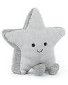 A plush star-shaped toy in light gray with a smiling face, black button eyes, and two small gray legs. The sides of the star have a slightly shimmery silver texture.