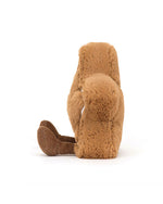 Plush toy of a brown furry animal with long limbs, sitting with legs stretched out, featuring a soft fluffy texture and corduroy-like material on its feet.