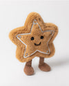 Plush toy shaped like a light brown star with five points outlined in white stitching and silver dots at the tips, featuring black button eyes, a smiling mouth, and two short brown legs resembling socks or boots.