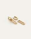 Set of gold link earrings with a modern, elongated oval design and hinged closure, displayed on a light neutral background.
