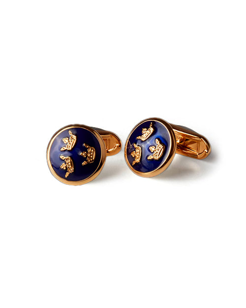 Gold and blue cufflinks with three crowns design on a white background
