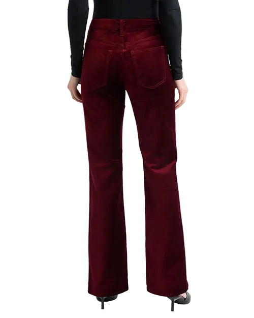 Model wearing burgundy velvet straight-leg pants paired with black pointed-toe heels.