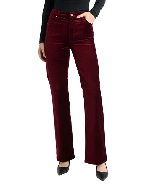 Model wearing burgundy velvet straight-leg pants paired with black pointed-toe heels.
