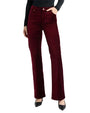 Model wearing burgundy velvet straight-leg pants paired with black pointed-toe heels.
