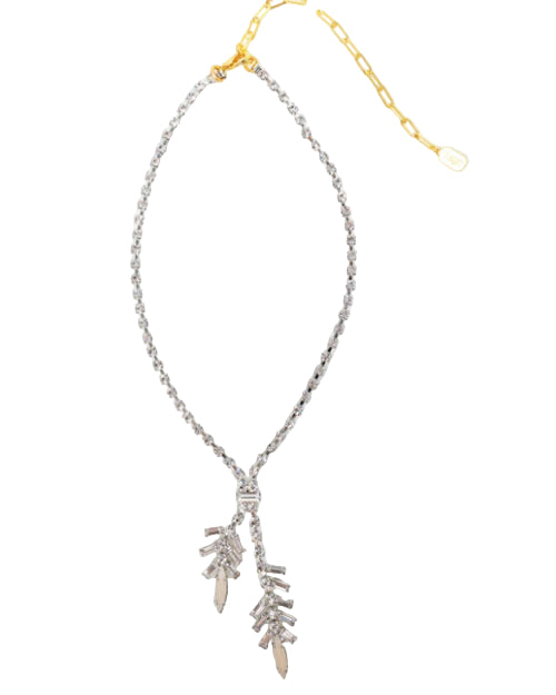 A silver-toned necklace with small crystal stones and a gold chain extender, featuring two dangling branch-like pendants made of stacked metallic bars, displayed on a white background.