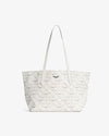 White leather tote bag with an open-top design, featuring a diamond-patterned perforated detail and two long shoulder straps, displayed against a plain white background.