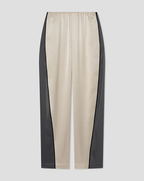 Beige satin pants with dark green side panels and an elastic waistband.