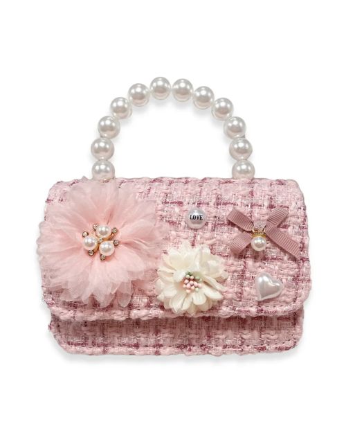  A pink purse adorned with pearls and floral embellishments, showcasing a stylish and elegant design.