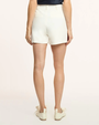 Person wearing white shorts on a plain background