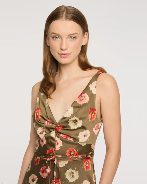 Woman wearing a floral dress on a plain background