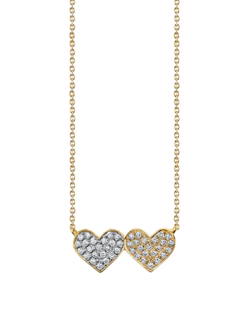 Gold necklace with two heart-shaped pendants on a white background
