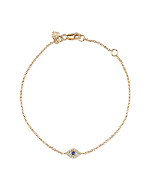 Gold bracelet with a blue gemstone and clear stones on a white background