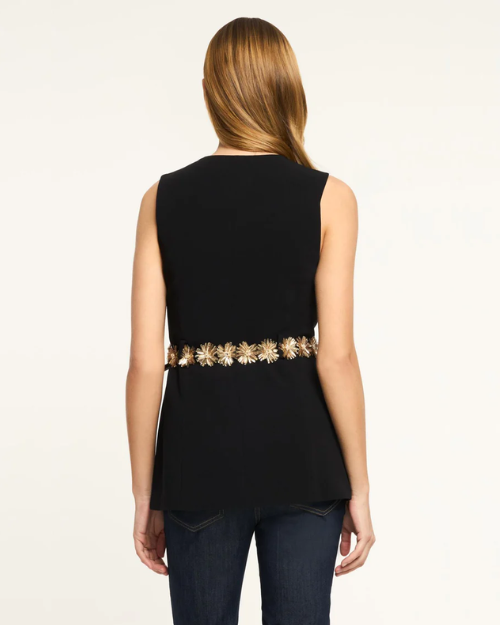 Black sleeveless top with a decorative gold waistband worn by a person on a white background