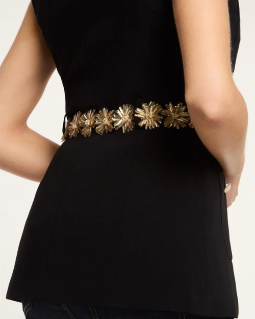 Black sleeveless top with a decorative gold belt on a plain background