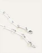 Close-up of silver chain necklace, showcasing adjustable clasp closure.