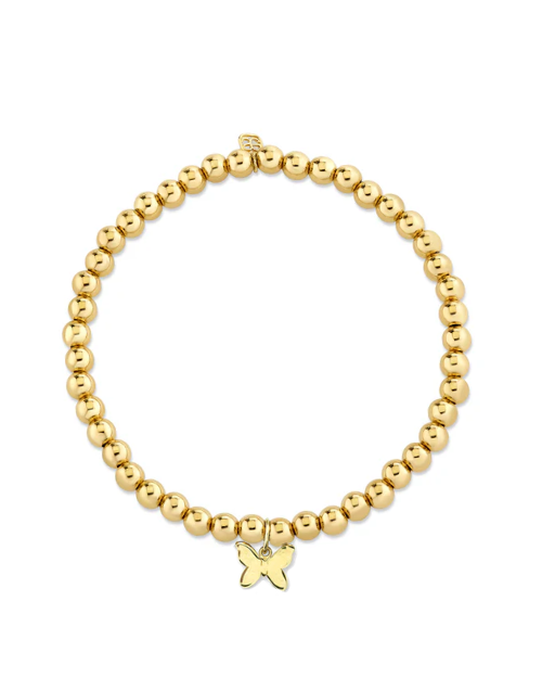 Gold beaded bracelet with a gold butterfly charm on a white background