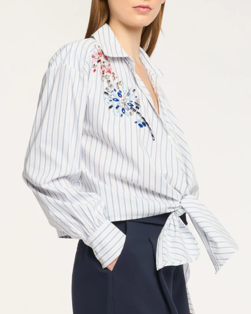 White and blue striped shirt with floral embroidery on a white background