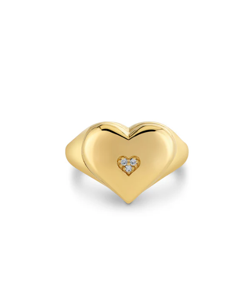 Gold heart-shaped ring with a smaller heart inset on a white background