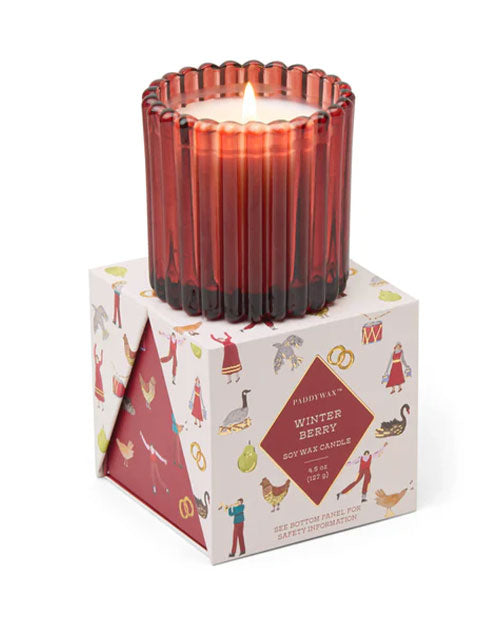 A candle atop a box, showcasing a red candle nestled within.