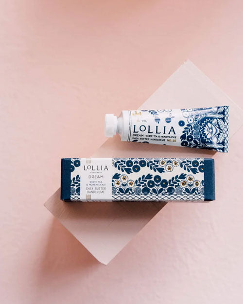 Lollia hand cream in blue and white, enriched with Macadamia Nut and Avocado Oils for soothing, hydrating skin.