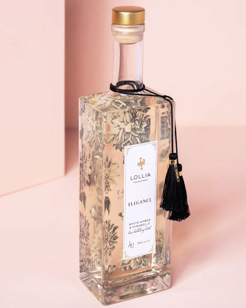 An elegant bottle topped with a decorative tassel, emphasizing its distinctive and refined appearance.