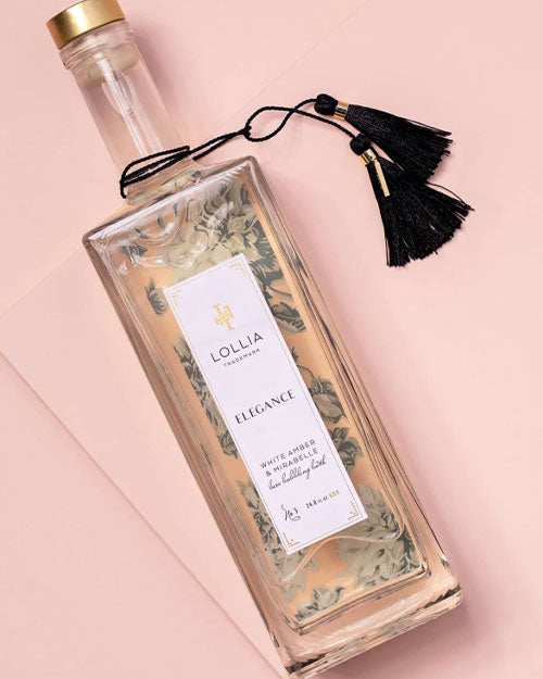 A bottle adorned with a decorative tassel on the top, showcasing its unique design.