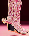  A decorative pink cowboy boot with gold spur ornament embellished with sparkling crystals, perfect for holiday tree decor.