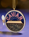 A Christmas tree ornament, displaying the word "caviar."