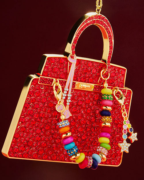A festive red purse ornament decorated with vibrant beads, perfect for holiday decor.