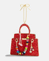 A red purse ornament featuring colorful beads, adding a cheerful touch to Christmas decorations.