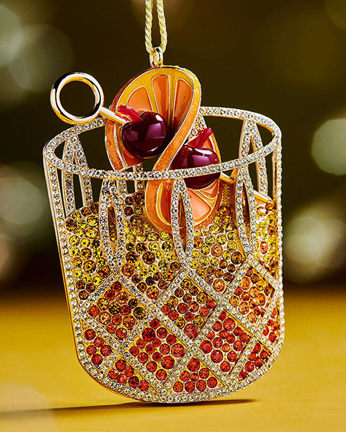  A festive Christmas ornament featuring a cocktail served in a glass, adding a playful touch to holiday decorations.