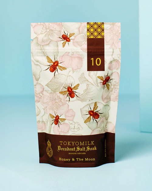 A decorative bag of salt soak adorned with a flower pattern and images of bees.
