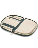 Forest green travel jewelry case, featuring compartments for jewelry, including earring holders and a mirror.