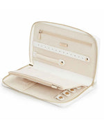 A white jewelry travel case with a gold zipper opened to show the earring tab, ring, tab, and zipper compartment. 