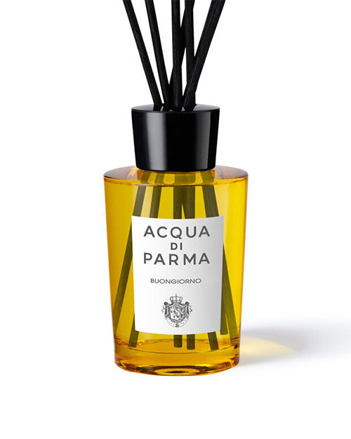 Acqua Parma diffuser displayed in an elegant glass bottle with natural reeds for fragrance diffusion.