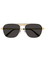 A pair of sunglasses with dark lenses and a gold and silver frame. The brand name 'Cartier' is visible on the top left lens.