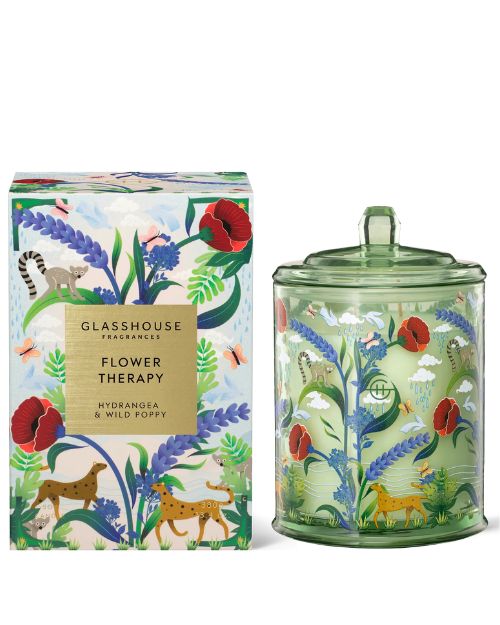 Glasshouse candle titled "Flower of the Forest," adorned with a colorful floral pattern, exuding a calming ambiance.