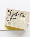 A vibrant card displaying the message "Wishing you so much good juju" in cheerful lettering, surrounded by decorative elements.