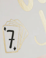 Detailed view of a gold foil card showcasing the number seven in an elegant font.