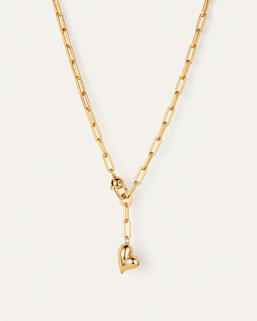 A gold heart necklace displayed on a delicate chain, showcasing its elegant design and shiny finish.

