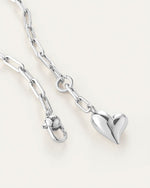 A silver heart necklace featuring a delicate chain, elegantly designed for a timeless look.