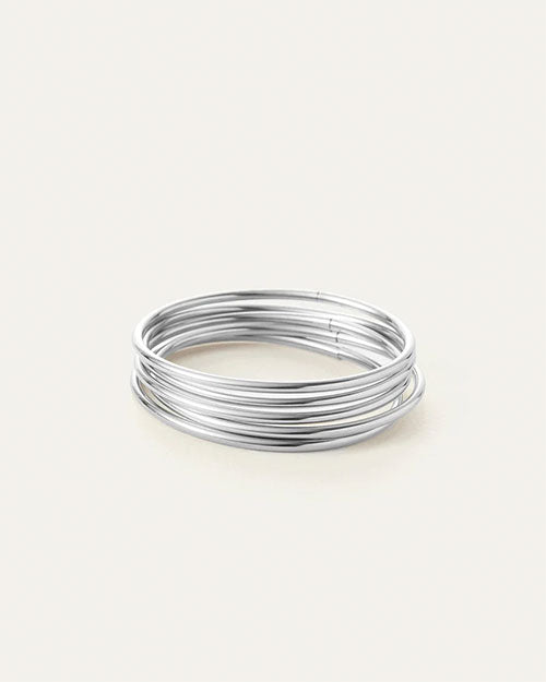 A stack of shiny silver wire bangles arranged neatly on a clean white background.